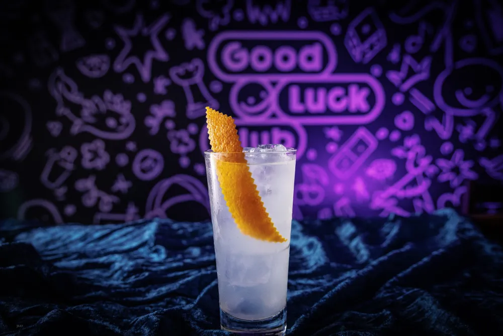 Kid-A Collins with a long citrus peel, in front of the mural