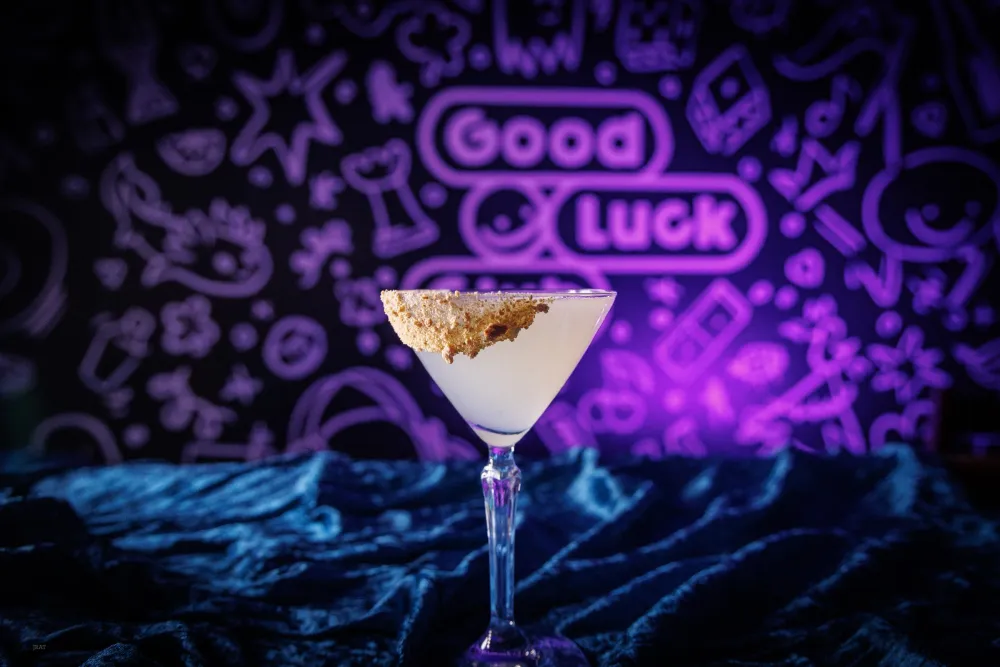 Stonefruit Lemon Drop in a coupe with a crumb rim