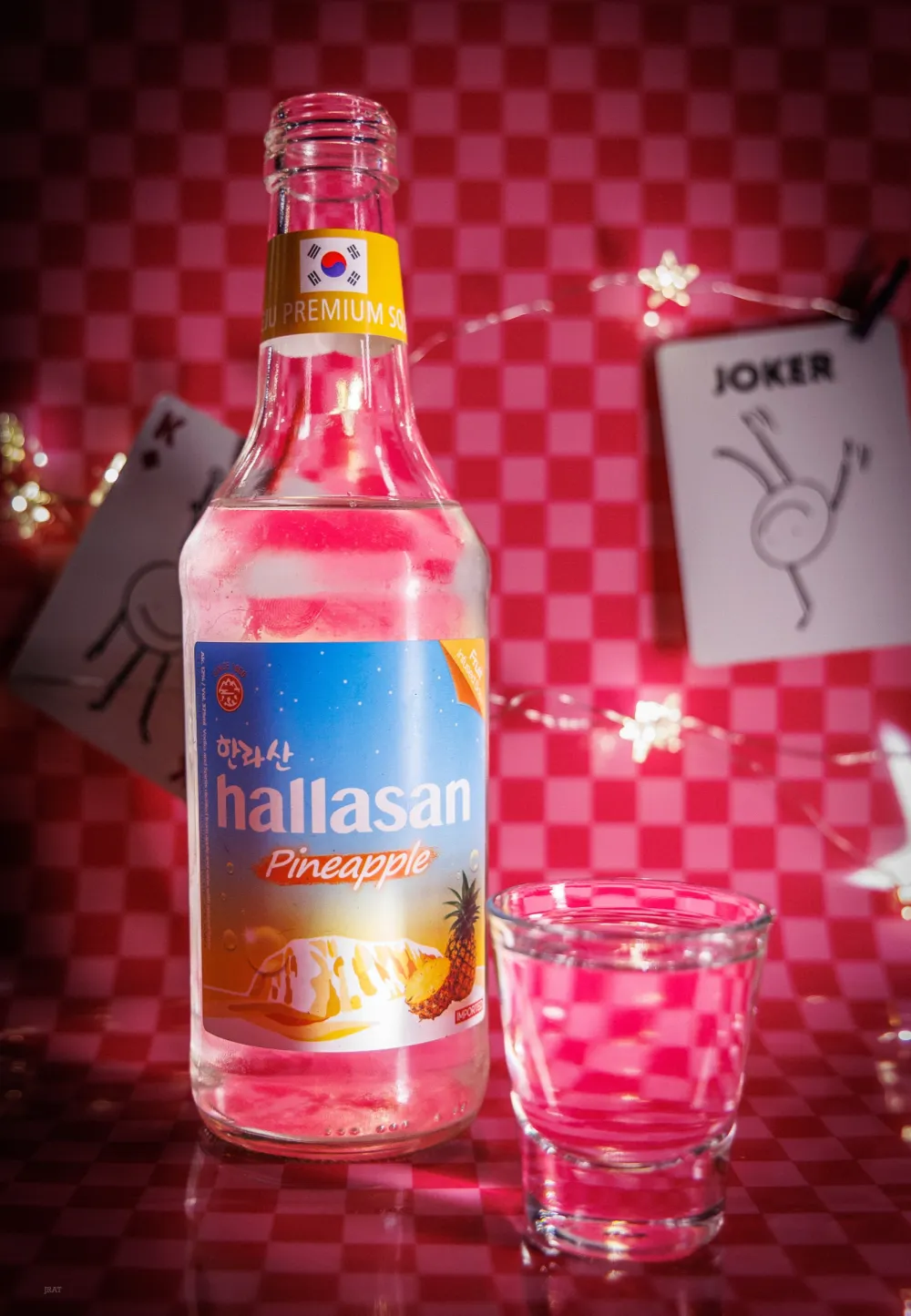 Pineapple soju bottle next to a shot glass