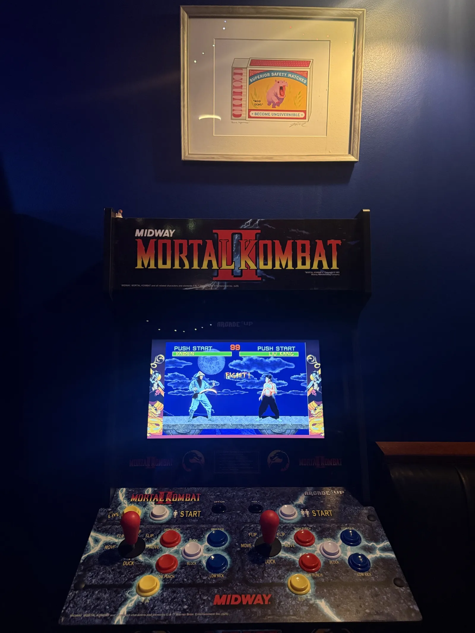 A Mortal Kombat II arcade cabinet against a dark blue wall
